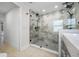 Modern bathroom featuring walk-in shower with rain shower head and stylish tiling at 9204 Wood Lake Blvd, Tampa, FL 33615