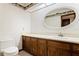 Traditional bathroom featuring an oval mirror, solid surface vanity and unique chicken-themed wallpaper border at 1007 Lakewood Dr, Brandon, FL 33510