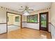 Dining space featuring hardwood floors and a ceiling fan with adjacent door leading to the yard at 1007 Lakewood Dr, Brandon, FL 33510