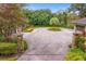 Circular driveway with stone pillars and lush landscaping, leading to the home at 1007 Lakewood Dr, Brandon, FL 33510