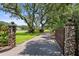 Long driveway leading to the residence, framed by stone pillars and mature trees at 1007 Lakewood Dr, Brandon, FL 33510