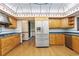 Another view of the kitchen featuring wood cabinets, stainless steel appliances, and modern lighting at 1007 Lakewood Dr, Brandon, FL 33510