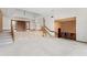 Spacious living room featuring plush carpeting, a stone accent wall, and an adjacent bar area for entertaining at 1007 Lakewood Dr, Brandon, FL 33510