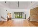 Bright open living room featuring hardwood floors, large windows, and a stone accent wall at 1007 Lakewood Dr, Brandon, FL 33510