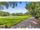 Scenic property view showcasing the driveway, lush lawn, pond and home at 1007 Lakewood Dr, Brandon, FL 33510