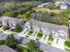 Aerial view of townhomes showcasing lush landscaping and community layout at 10120 Post Harvest Dr, Riverview, FL 33578