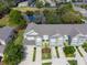 Aerial view of townhomes with manicured lawns and a scenic pond at 10120 Post Harvest Dr, Riverview, FL 33578