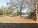 View of backyard featuring a scenic pond with a variety of trees at 10120 Post Harvest Dr, Riverview, FL 33578