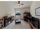 A versatile spare bedroom featuring a treadmill, desk, and a ceiling fan at 10120 Post Harvest Dr, Riverview, FL 33578