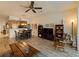 Spacious living room featuring a ceiling fan and wooden coffee table at 10120 Post Harvest Dr, Riverview, FL 33578