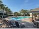 Community pool with lounge chairs, patio furniture, and a covered pavilion at 10120 Post Harvest Dr, Riverview, FL 33578