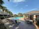 Community pool with lounge chairs, patio furniture, and a covered pavilion at 10120 Post Harvest Dr, Riverview, FL 33578