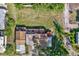 Overhead view of a home with a spacious backyard, decks, and additional structures on the property at 10455 14Th Ne St, St Petersburg, FL 33702