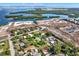 Beautiful aerial showing community near water; the home is surrounded by lush greenery in a developing area at 10455 14Th Ne St, St Petersburg, FL 33702