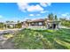 Exterior of a home with a carport and front yard with green grass and blue skies at 10455 14Th Ne St, St Petersburg, FL 33702