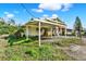 Exterior of a home with a white carport and a yard with patchy grass at 10455 14Th Ne St, St Petersburg, FL 33702