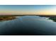 Panoramic aerial view of a wide lake, cityscape, and green vegetation at 10532 94Th Pl, Seminole, FL 33772