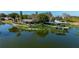 Waterfront home with lush landscaping, private dock, and tranquil water views from an aerial perspective at 10532 94Th Pl, Seminole, FL 33772