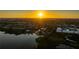 Panoramic aerial view of homes at sunset along the water at 10532 94Th Pl, Seminole, FL 33772