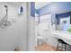 Clean bathroom with white vanity, tile floors and blue walls at 10532 94Th Pl, Seminole, FL 33772