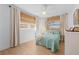 Bright bedroom with white walls, bamboo blinds and light-colored floor. Airy and serene at 10532 94Th Pl, Seminole, FL 33772