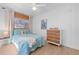 Cozy bedroom with neutral-toned walls and curtains, a ceiling fan and light wood floors at 10532 94Th Pl, Seminole, FL 33772