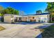 Inviting single-story home featuring carport, tidy landscaping, and a spacious concrete driveway at 10532 94Th Pl, Seminole, FL 33772