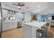 Bright kitchen with stainless steel appliances, white cabinets, and a view into an adjacent living space at 10532 94Th Pl, Seminole, FL 33772