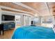 Bright main bedroom featuring a beamed wood ceiling, sliding glass doors and ensuite bathroom with sliding barn door at 10532 94Th Pl, Seminole, FL 33772