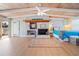 Spacious bedroom boasting wood-beam ceiling, a fireplace with decorative mantel, light wood floors and light walls at 10532 94Th Pl, Seminole, FL 33772