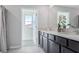 Double vanity bathroom with dark cabinets and quartz countertops at 10596 Farm Hill Ave, Land O Lakes, FL 34638