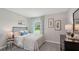 Well-lit bedroom with a queen bed and window at 10596 Farm Hill Ave, Land O Lakes, FL 34638