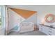 Bright Bedroom with crib, dresser, and geometric wall accents at 10596 Farm Hill Ave, Land O Lakes, FL 34638