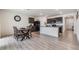 Kitchen and dining area with light wood flooring and a wooden dining table at 11976 Brighton Knoll Loop, Riverview, FL 33579