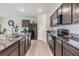 Open concept kitchen with stainless steel appliances and granite countertops at 11976 Brighton Knoll Loop, Riverview, FL 33579