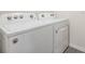 Laundry room with white Whirlpool washer and dryer at 11976 Brighton Knoll Loop, Riverview, FL 33579