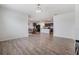 Open concept living room with wood flooring and view into kitchen and dining area at 11976 Brighton Knoll Loop, Riverview, FL 33579