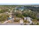 An aerial view of homes surrounded by trees near a pond and tennis courts at 1217 Carmella Ln, Sarasota, FL 34243