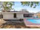 Pool area with fenced yard, screened patio and partial view of home's exterior at 1217 Carmella Ln, Sarasota, FL 34243