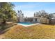 Back of house with pool, patio, fenced yard, and screened in back porch at 1217 Carmella Ln, Sarasota, FL 34243