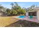 Backyard with a pool, chairs and view of the screened in lanai at 1217 Carmella Ln, Sarasota, FL 34243