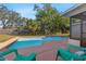 Backyard pool with patio and lounge chairs, partially fenced in at 1217 Carmella Ln, Sarasota, FL 34243