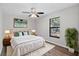 Bright bedroom with a ceiling fan, wood floor, and a large window at 1217 Carmella Ln, Sarasota, FL 34243