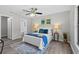 Serene bedroom with a ceiling fan, decor lighting, and a view of the backyard at 1217 Carmella Ln, Sarasota, FL 34243