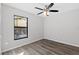 Bedroom with gray-toned wood-look plank flooring, neutral walls, and a window at 1217 Carmella Ln, Sarasota, FL 34243