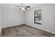 Empty bedroom featuring wood flooring, a ceiling fan, and a window at 1217 Carmella Ln, Sarasota, FL 34243