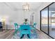 Cozy dining area near the pool, features a glass table, updated lighting, and sleek flooring at 1217 Carmella Ln, Sarasota, FL 34243