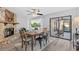 Dining room with a fireplace, table set, and view to adjacent kitchen at 1217 Carmella Ln, Sarasota, FL 34243