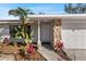 Inviting front entrance with stone accents and lush landscaping by the front door and garage at 1217 Carmella Ln, Sarasota, FL 34243