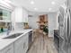 Bright, renovated kitchen with a stone fireplace adjacent to stainless steel appliances and quartz counters at 1217 Carmella Ln, Sarasota, FL 34243